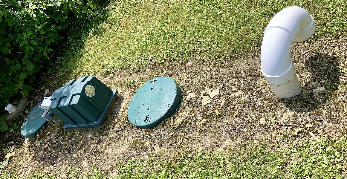 Septic tank riser lids at grade in a residential yard